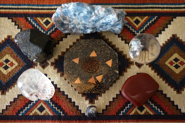 Orgone Generator surrounded by 6 stones (clockwise, starting at 12 o'clock): Blue Calcite, Quartz Sphere, Pipestone, Purpurite, Quartz Skull, Black Tourmaline.